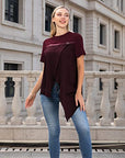 The T-shirt with irregular split and round neck design highlights a trendy and chic style