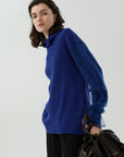 Elegant turtleneck sweater featuring mesh detail for style versatility