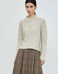 Chic Sweater with Irregular Hem, Ribbed Round Neck, and Colorful Dot Accents