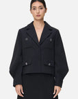 Elevate your style with this chic black coat, featuring a lapel V-neck and lantern sleeves for a sophisticated and unique look.