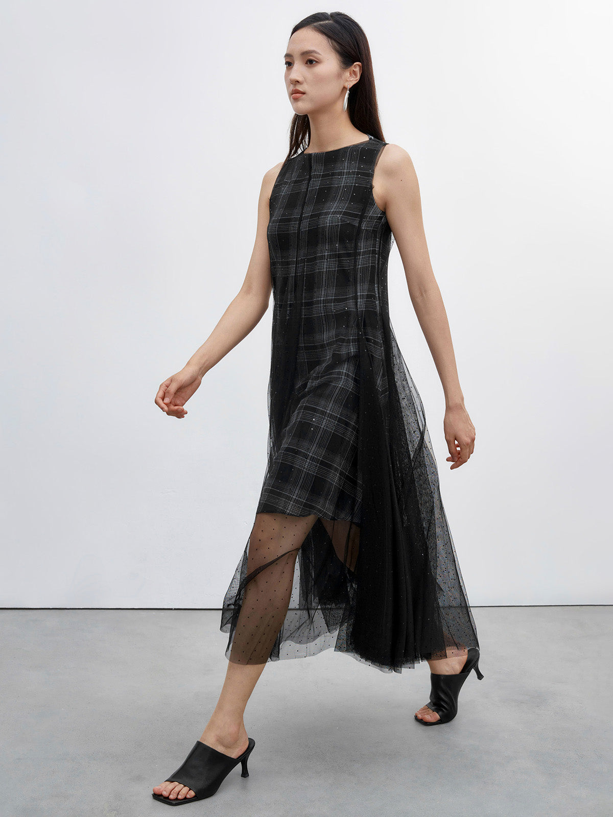 Side view of S·DEER black dress with a fitted top and flowing sheer tulle skirt