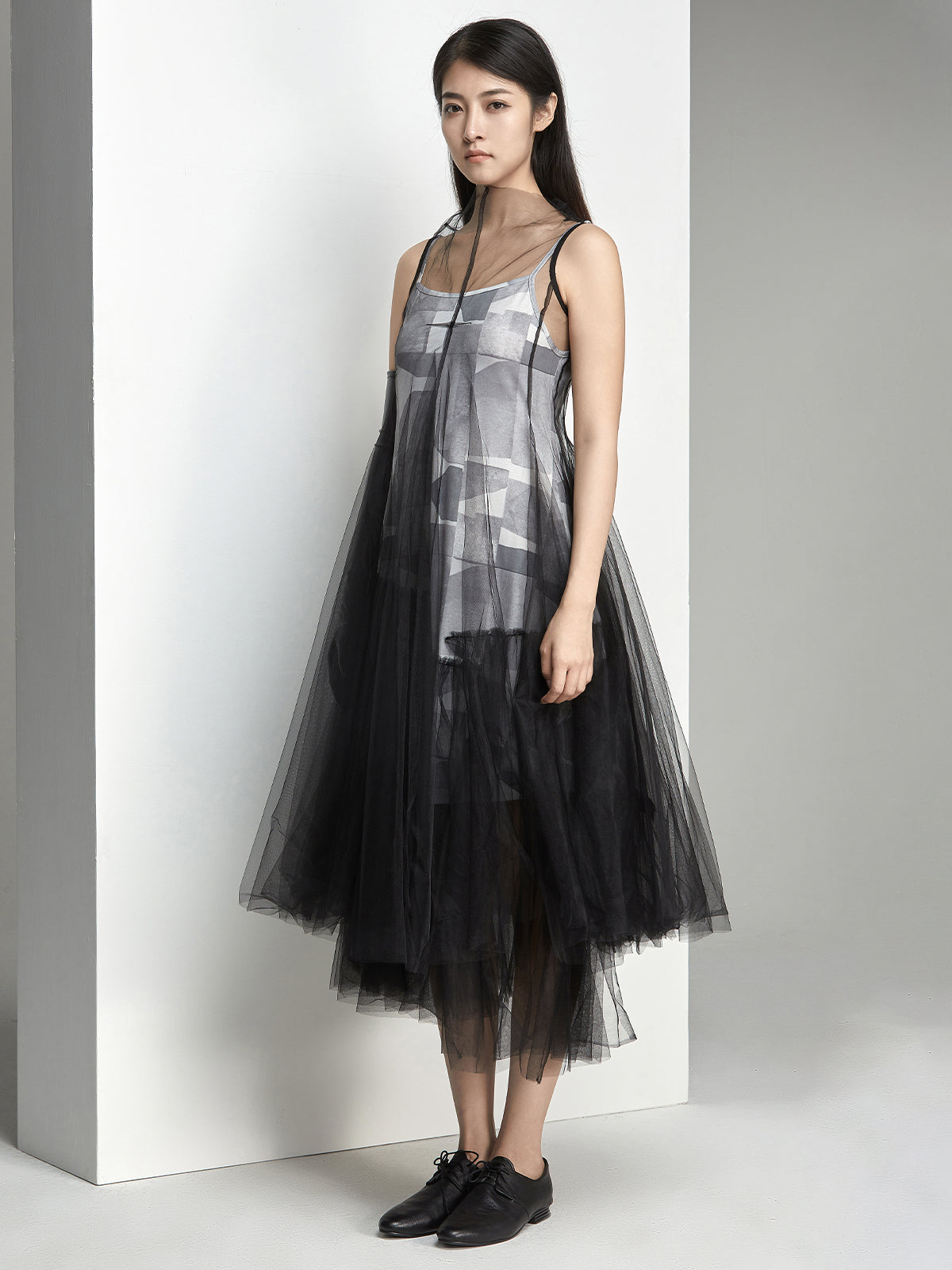 Side view of layered black tulle dress with sheer details