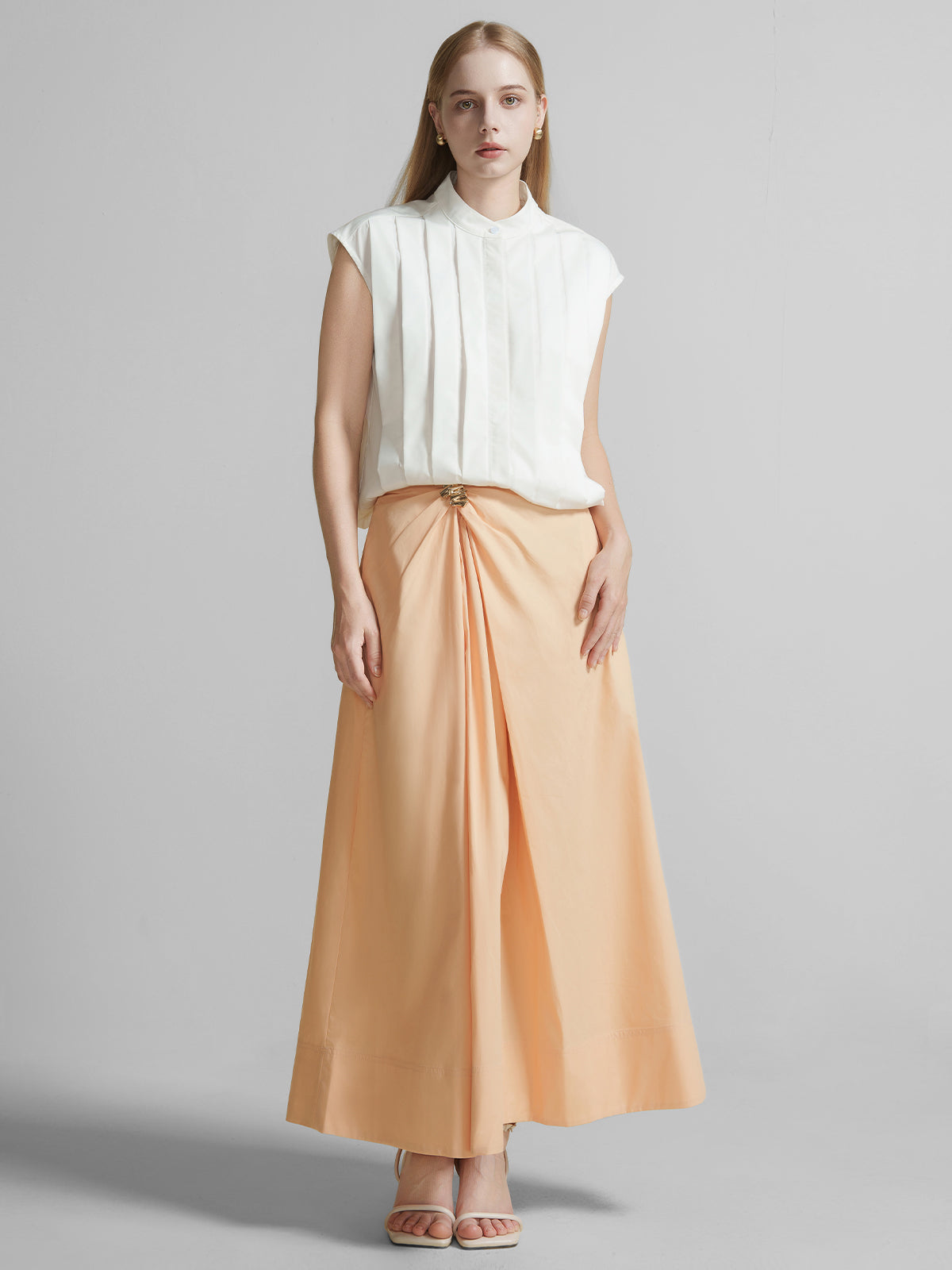 Peach high waist maxi A-line skirt for women with front twist detail, metal buckle accent, perfect for summer vacation outfits
