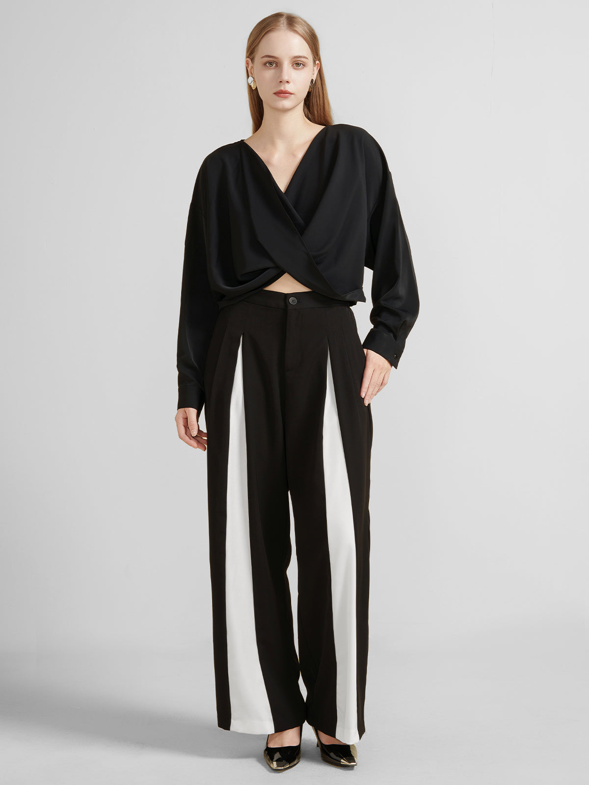 Women&#39;s black draped crossover blouse with long sleeves and a deep V-neck