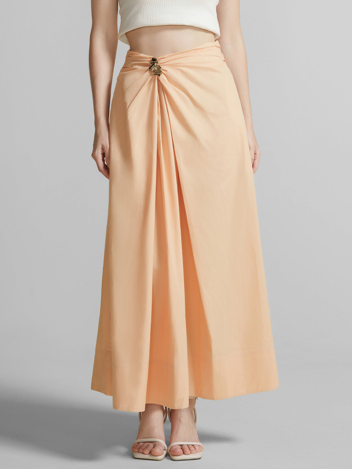 Peach high waist maxi A-line skirt for women with front twist detail, metal buckle accent, perfect for summer vacation outfits