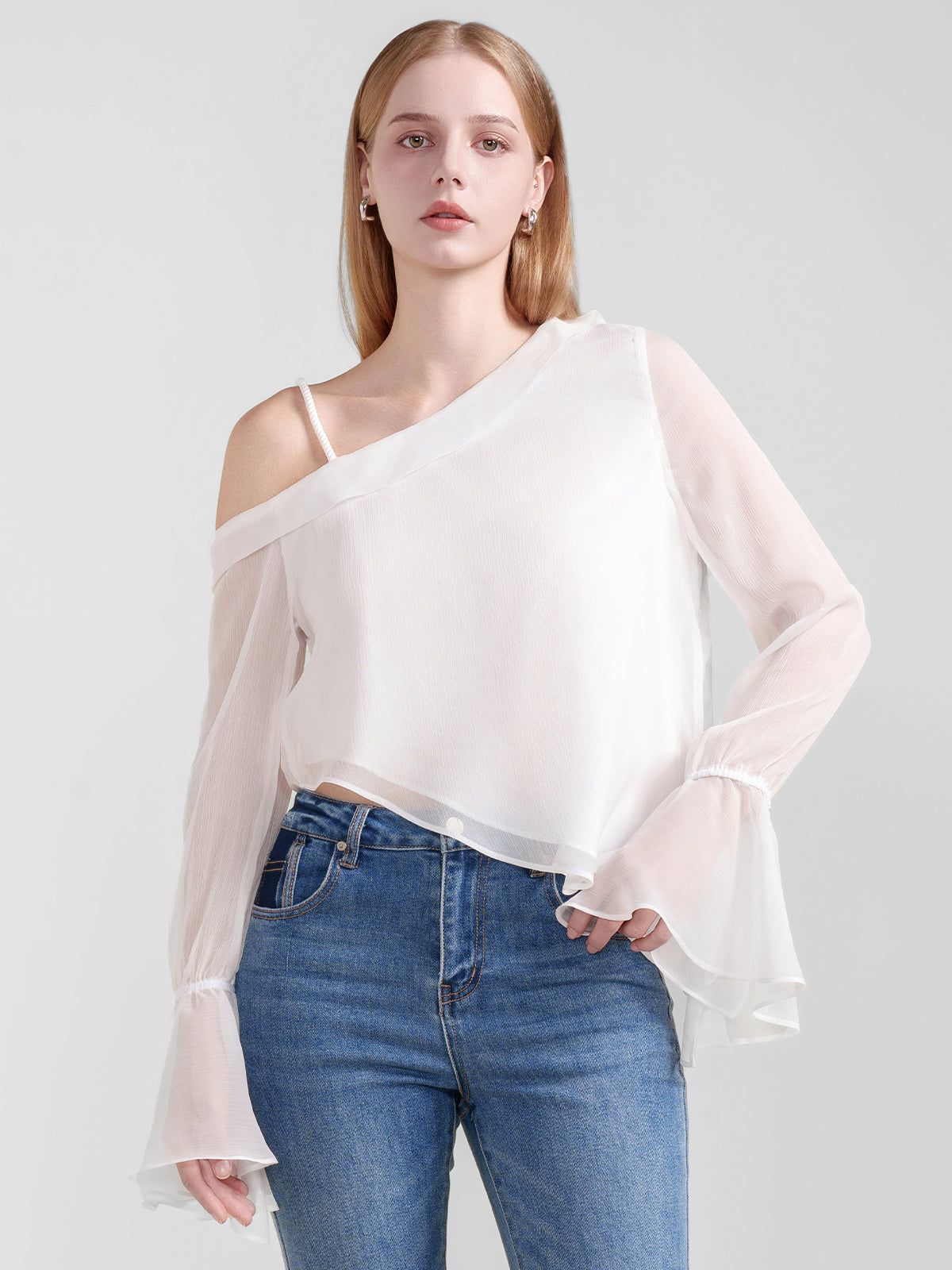 Romantic off-the-shoulder white blouse with sheer long sleeves and a relaxed, feminine fit