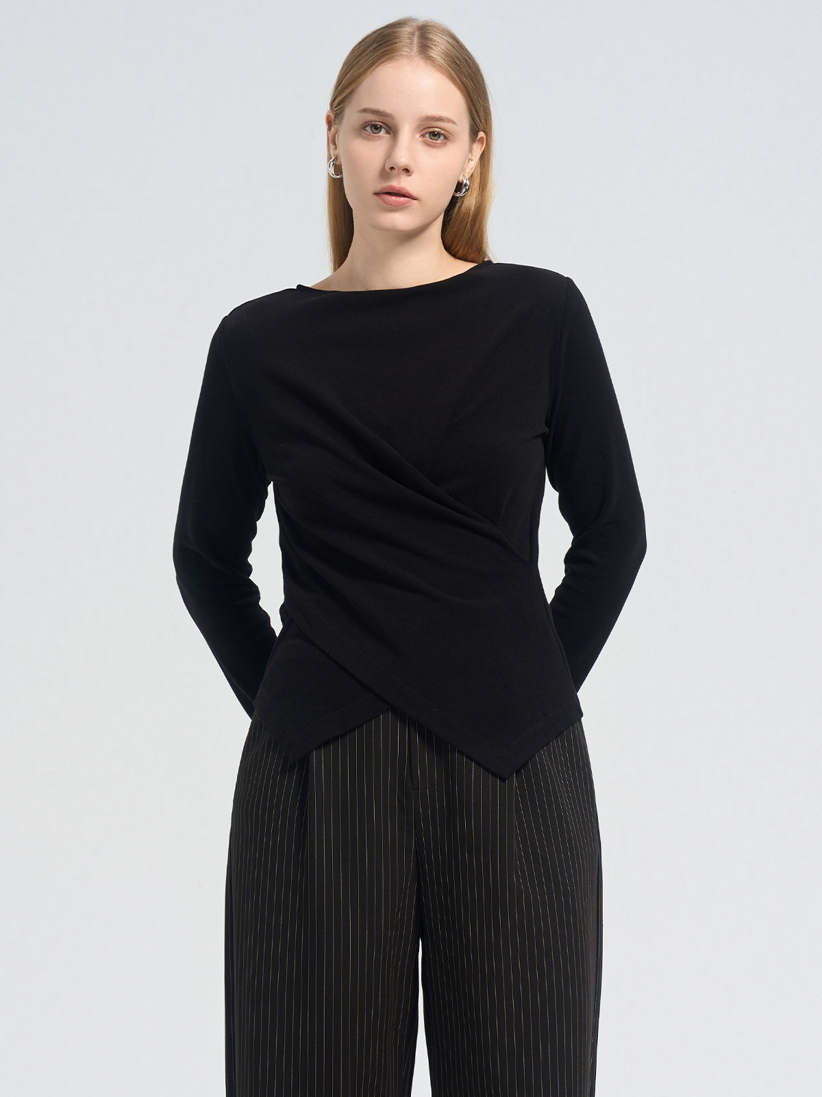 Asymmetric black long-sleeve top with a crossover pleated front