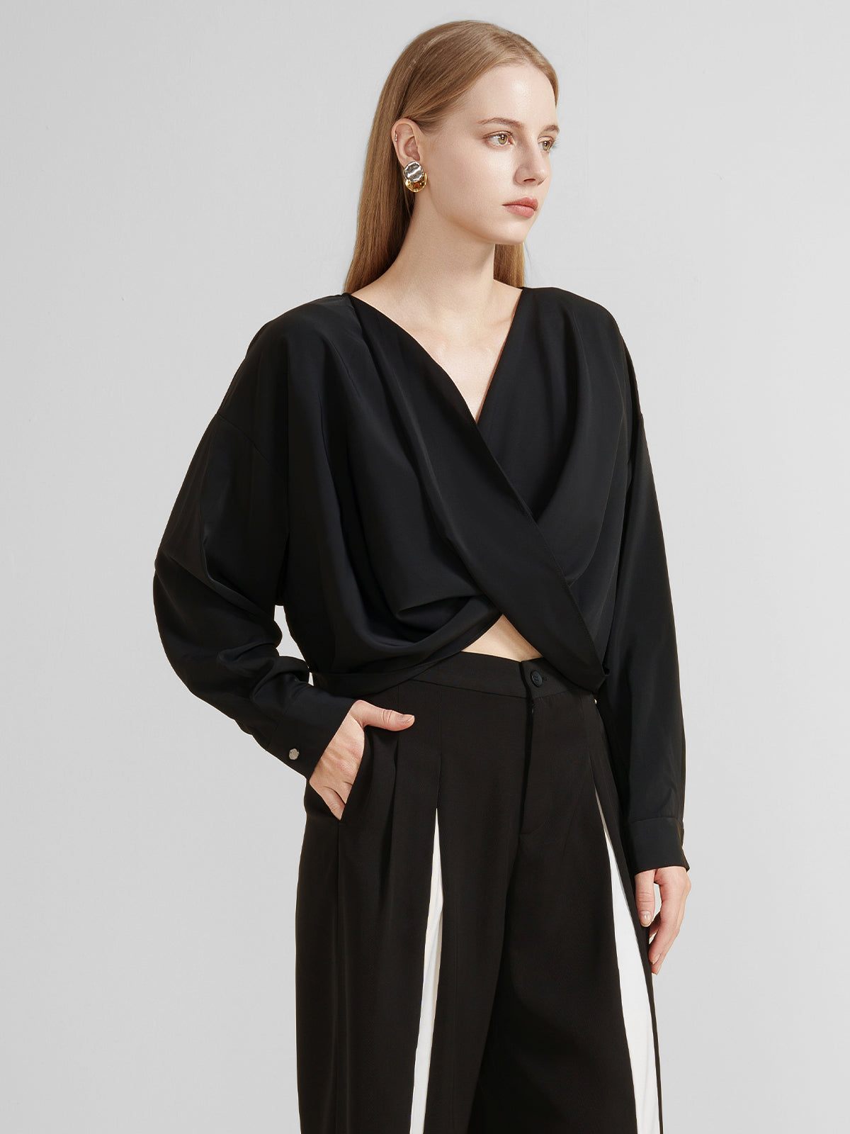 Women&#39;s black draped crossover blouse with long sleeves and a deep V-neck