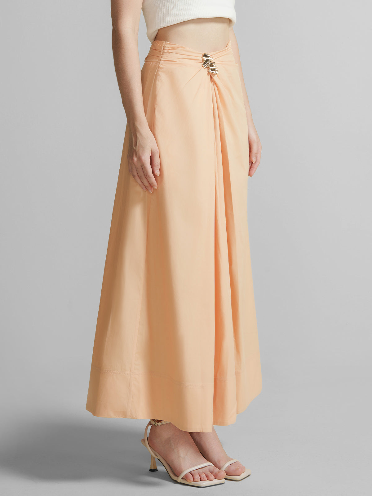 Peach high waist maxi A-line skirt for women with front twist detail, metal buckle accent, perfect for summer vacation outfits