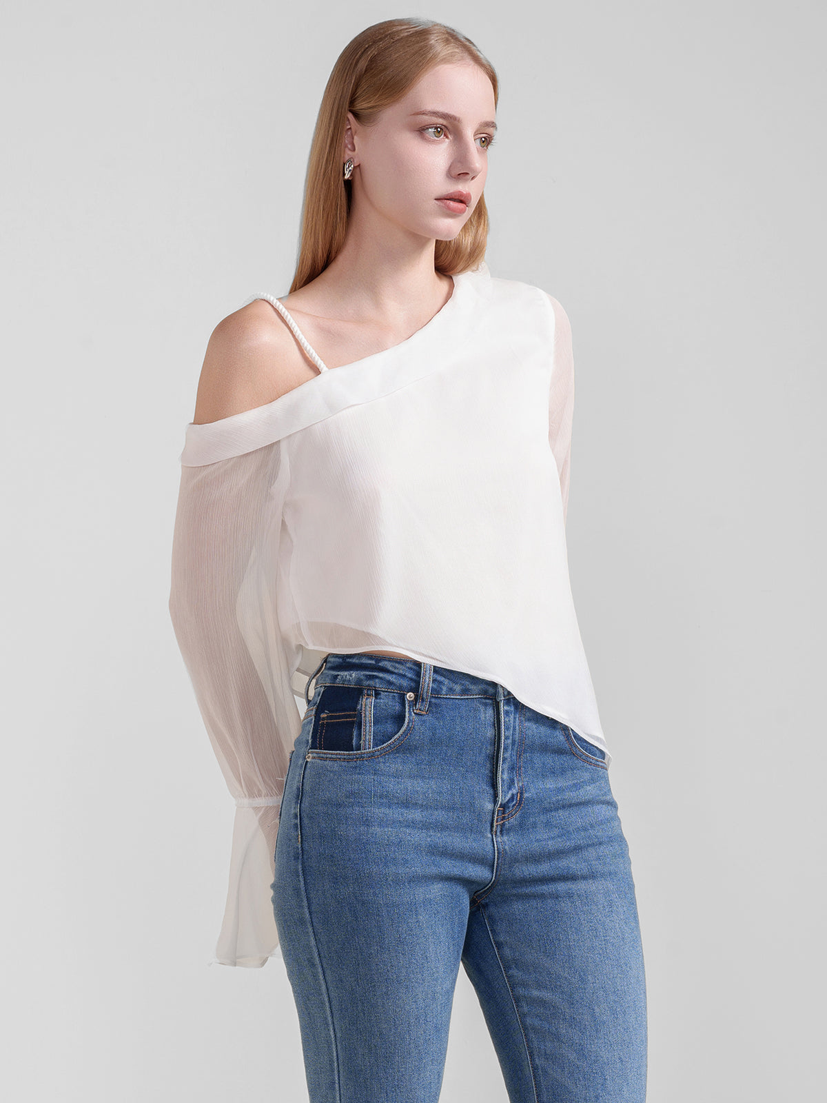 Elegant sheer white top with one-shoulder design, delicate strap detail, and ruffled bell sleeves