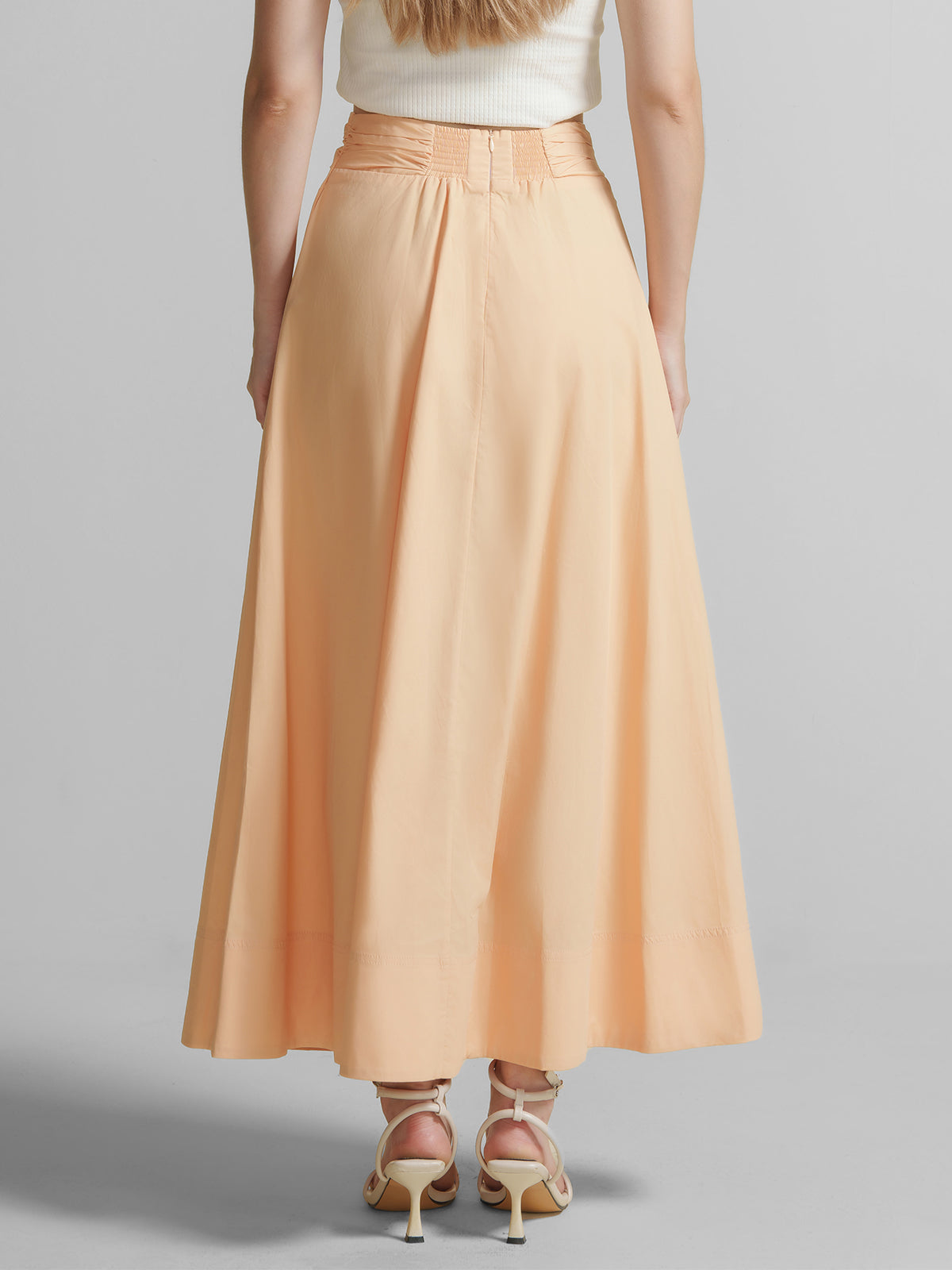 Peach high waist maxi A-line skirt for women with front twist detail, metal buckle accent, perfect for summer vacation outfits