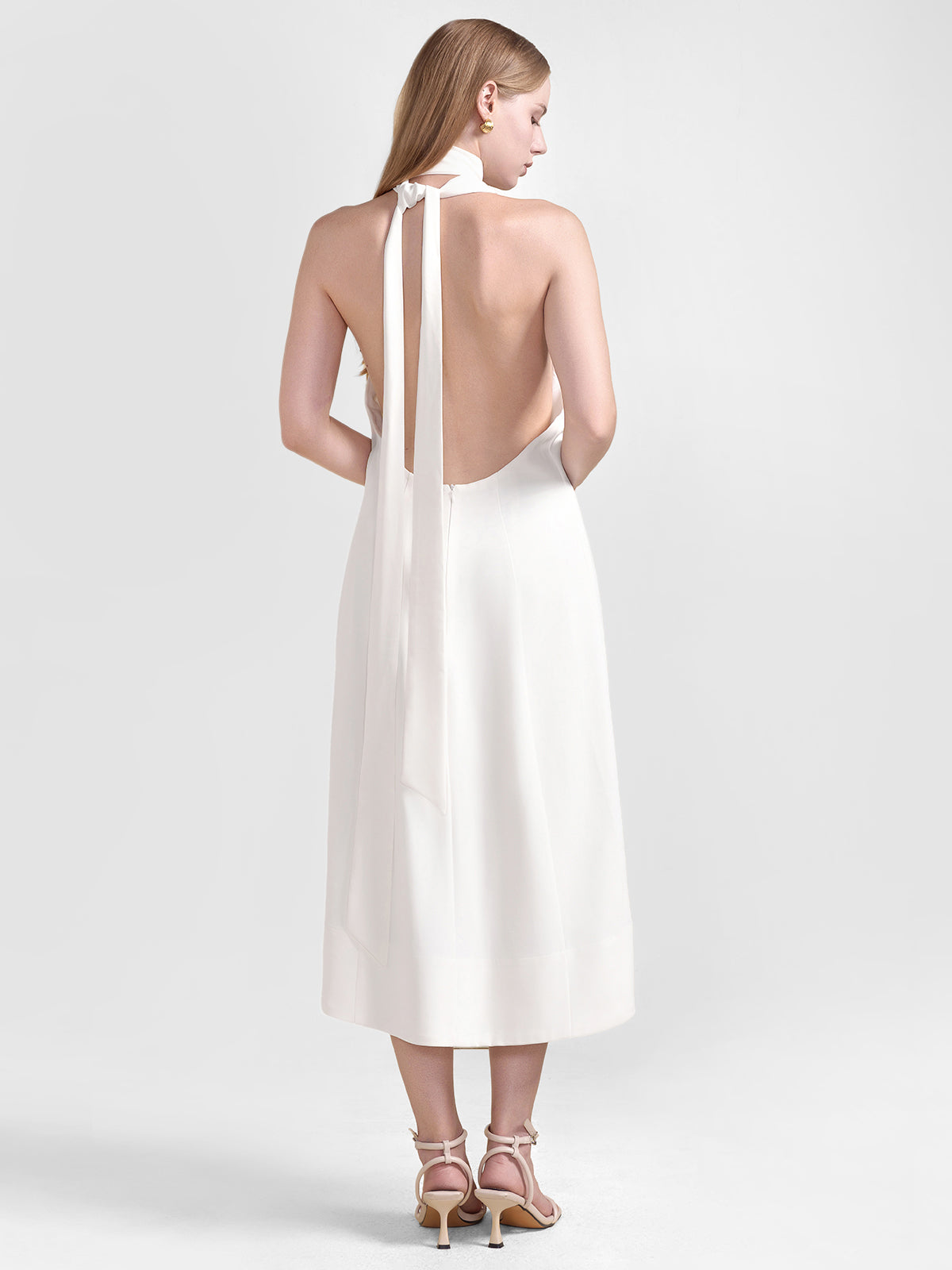 S·DEER white backless halter neck dress, highlighting its chic minimalistic design with a focus on the halter neck and waist drawstring