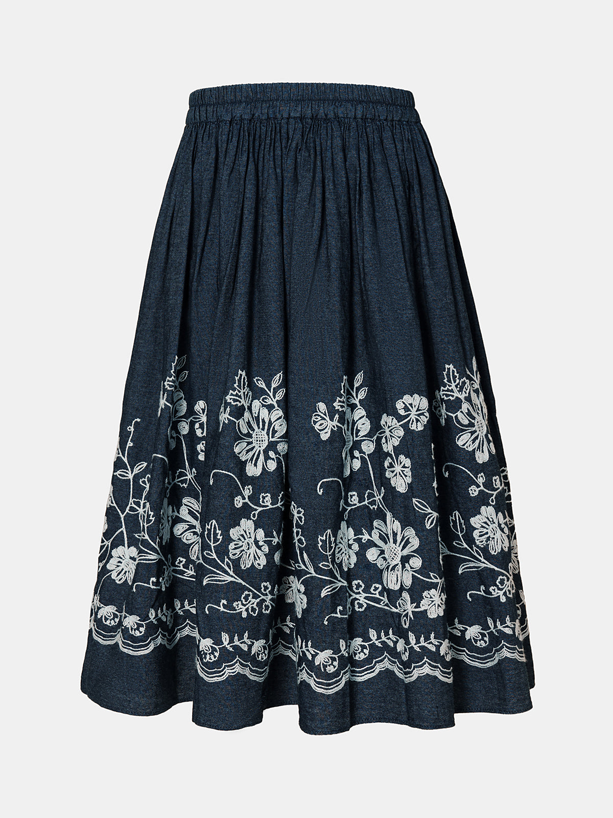 Dark blue cotton midi skirt with delicate white floral embroidery, high-waisted design, and flared A-line silhouette, offering breathable comfort and vintage charm for summer outfits