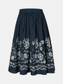 Dark blue cotton midi skirt with delicate white floral embroidery, high-waisted design, and flared A-line silhouette, offering breathable comfort and vintage charm for summer outfits