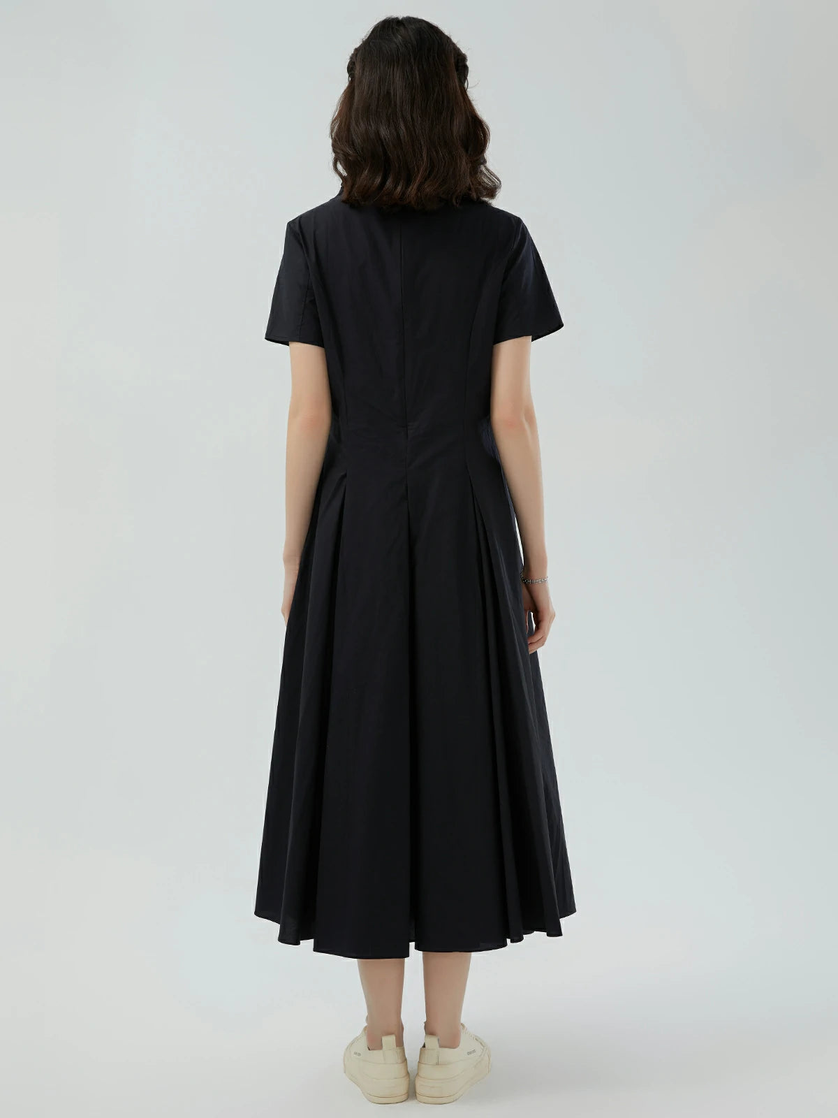 Back view of a vintage solid-color short sleeve maxi dress with front pleats