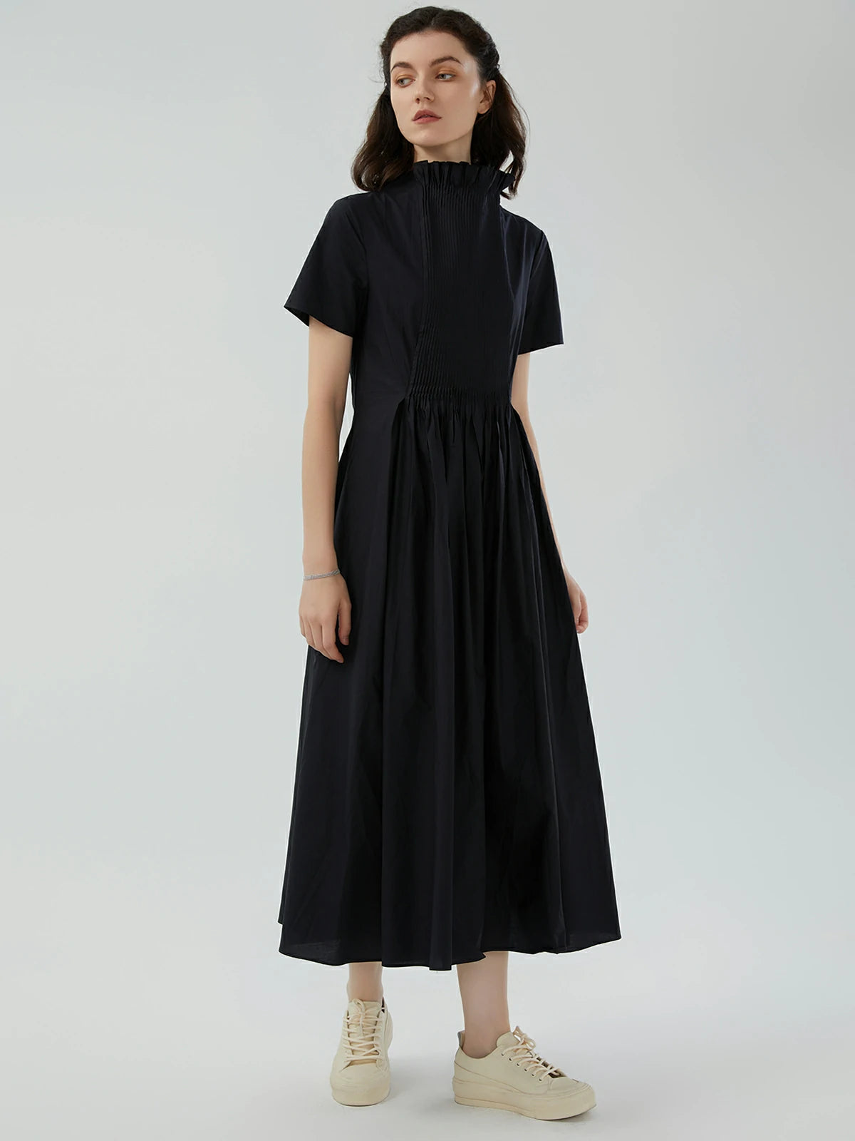 Side view of a retro maxi dress with a ruffle collar, front pleats, and short sleeves