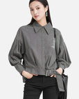 The waist-cinched design of the long-sleeve letter striped shirt showcasing the graceful curves of women