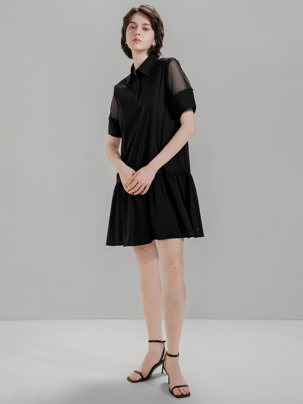 Flat-lay of S·DEER black shirt dress with mesh sleeves and tiered skirt