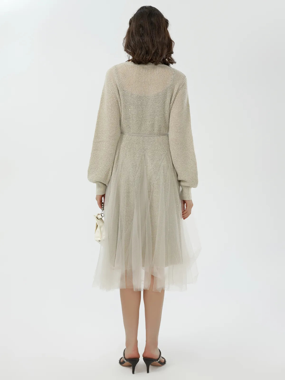 Back view of beige sweater dress featuring a cinched waist and soft knit texture.