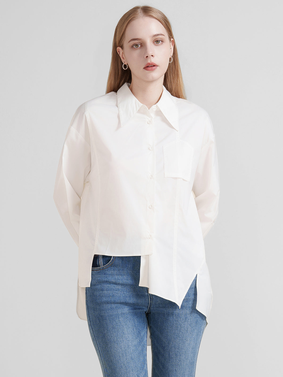 Chic white asymmetrical blouse featuring a single chest pocket and drop shoulders