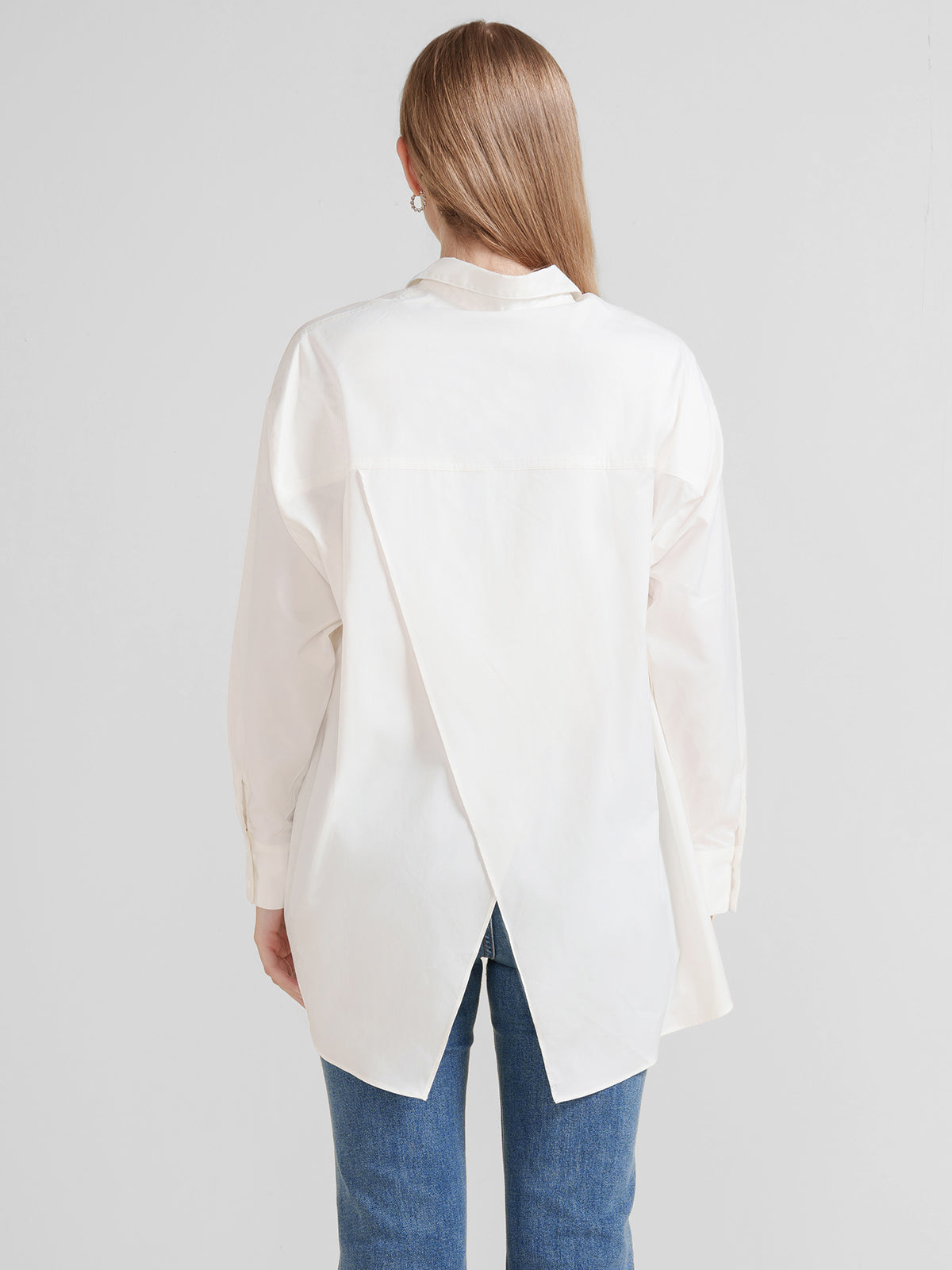 Modern oversized white shirt with an irregular hemline, perfect for layering