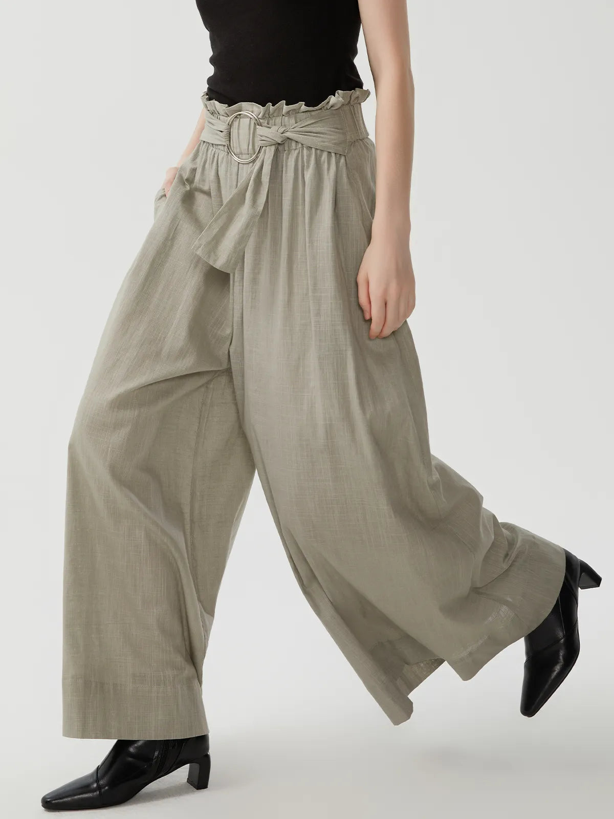 High-waisted linen trousers with a vintage aesthetic and natural texture