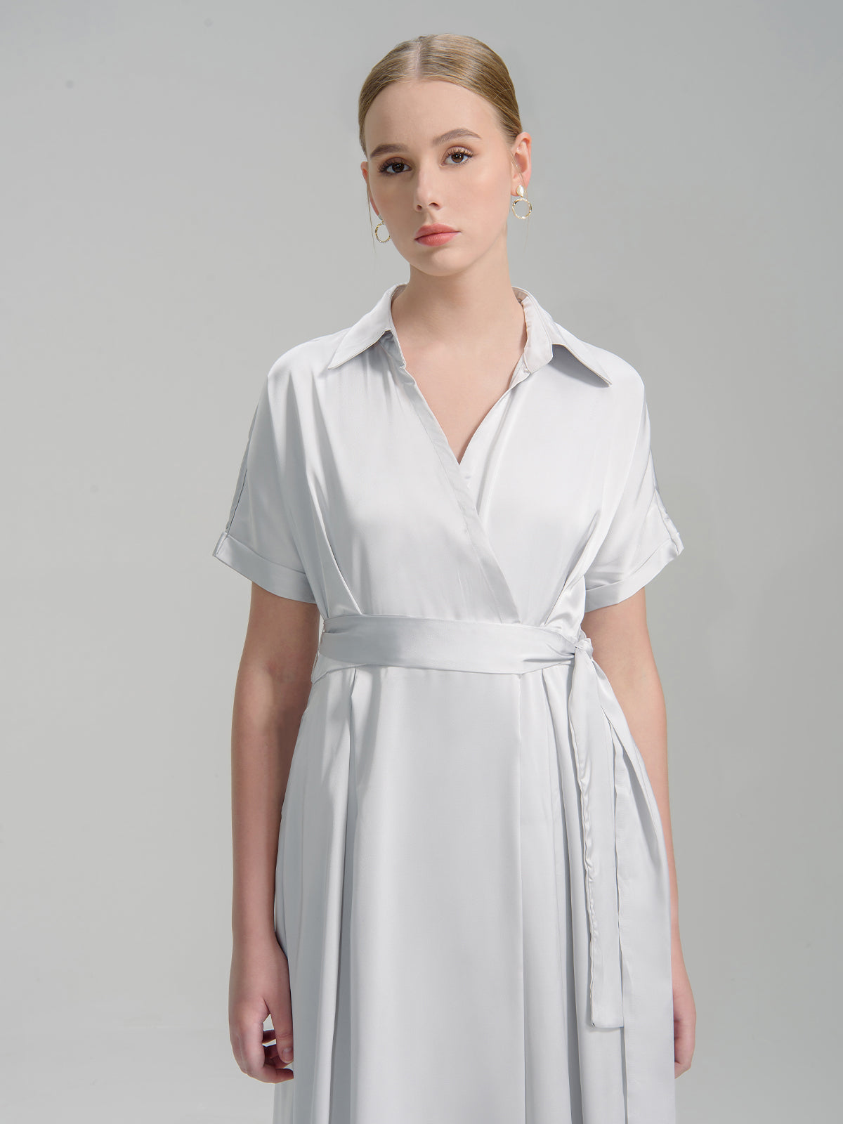 silver wrap dress with a collar, short sleeves, and a belted waist
