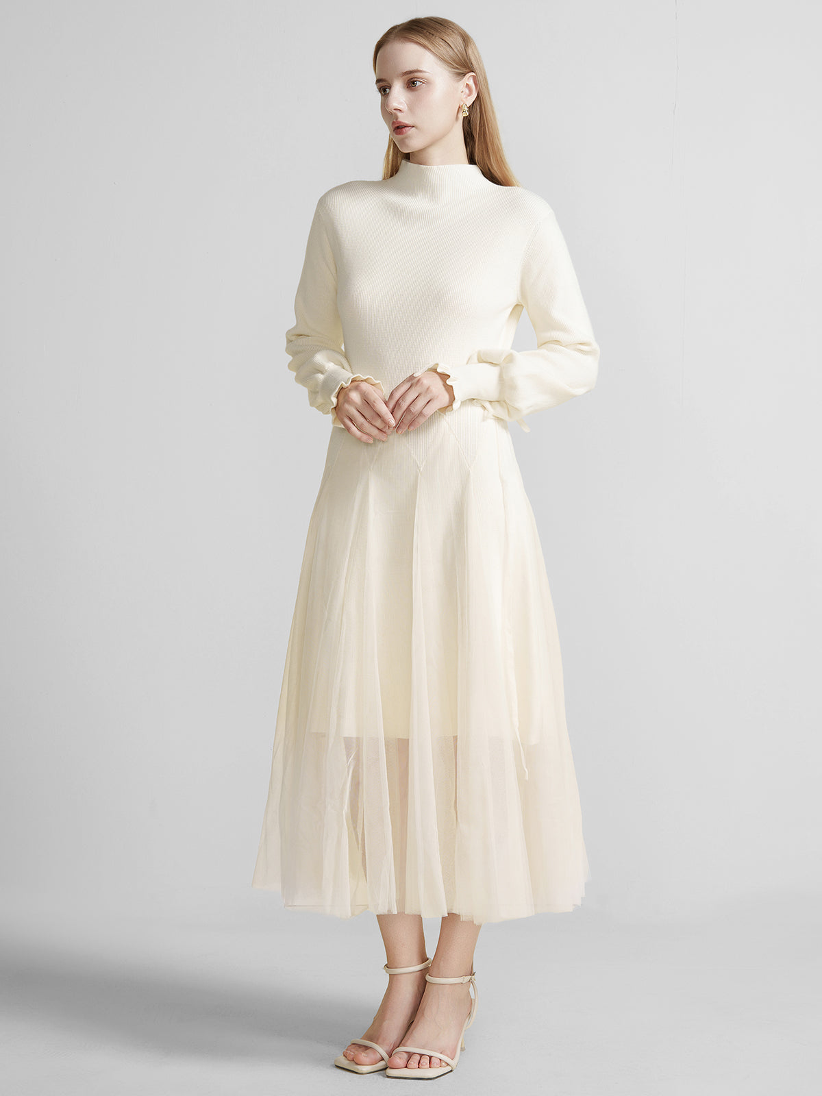 S·DEER ivory knit dress with high collar, long sleeves, and a flowing tulle skirt