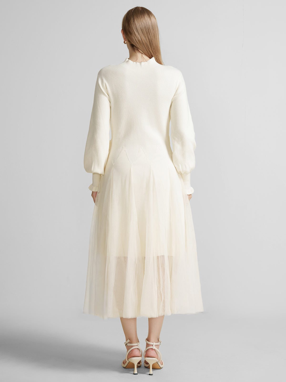 Back view of S·DEER ivory dress with high neck, ribbed knit top, and layered tulle skirt