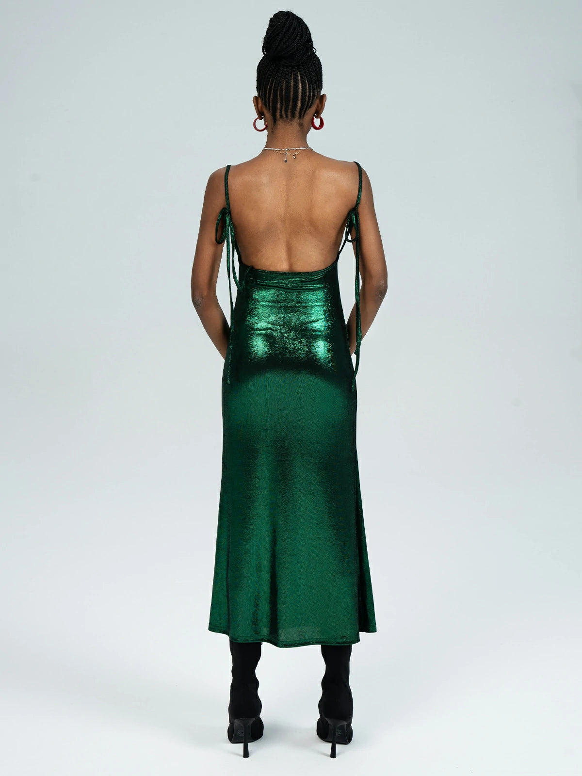 Adorned with a vibrant green glossy finish, this chic dress features a square neckline and side slit for a fashion-forward statement.