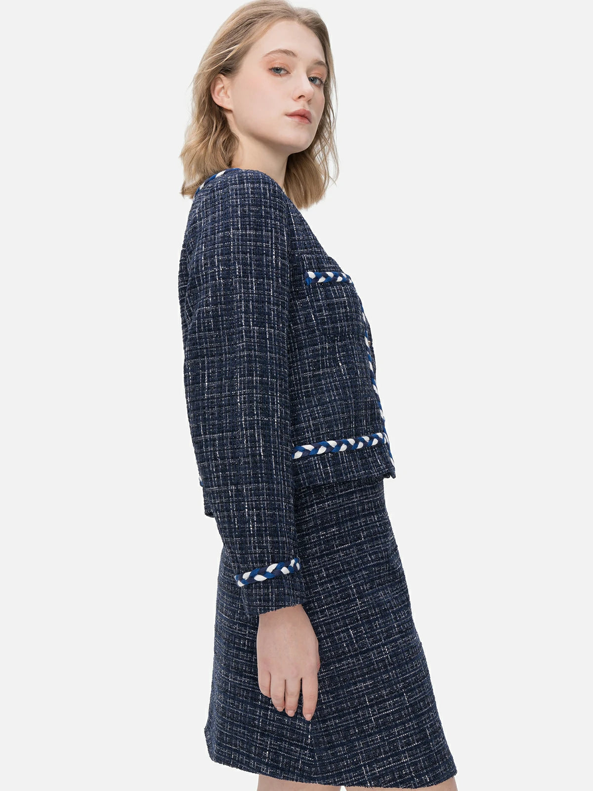 Redefine your wardrobe with this navy blue plaid jacket featuring a delicate touch of romance through camellia-shaped buttons, blending classic elegance with a tailored design.