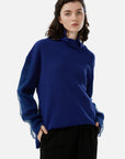 Solid turtleneck sweater with mesh sleeves for versatile styling
