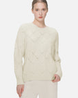 Soft and form-fitting round-neck sweater with diamond-cutout pattern.