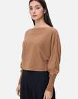 Elevate your winter wardrobe with this chic cashmere sweater, boasting a short length and stylish batwing sleeves in a versatile solid color for a modern and cozy look.