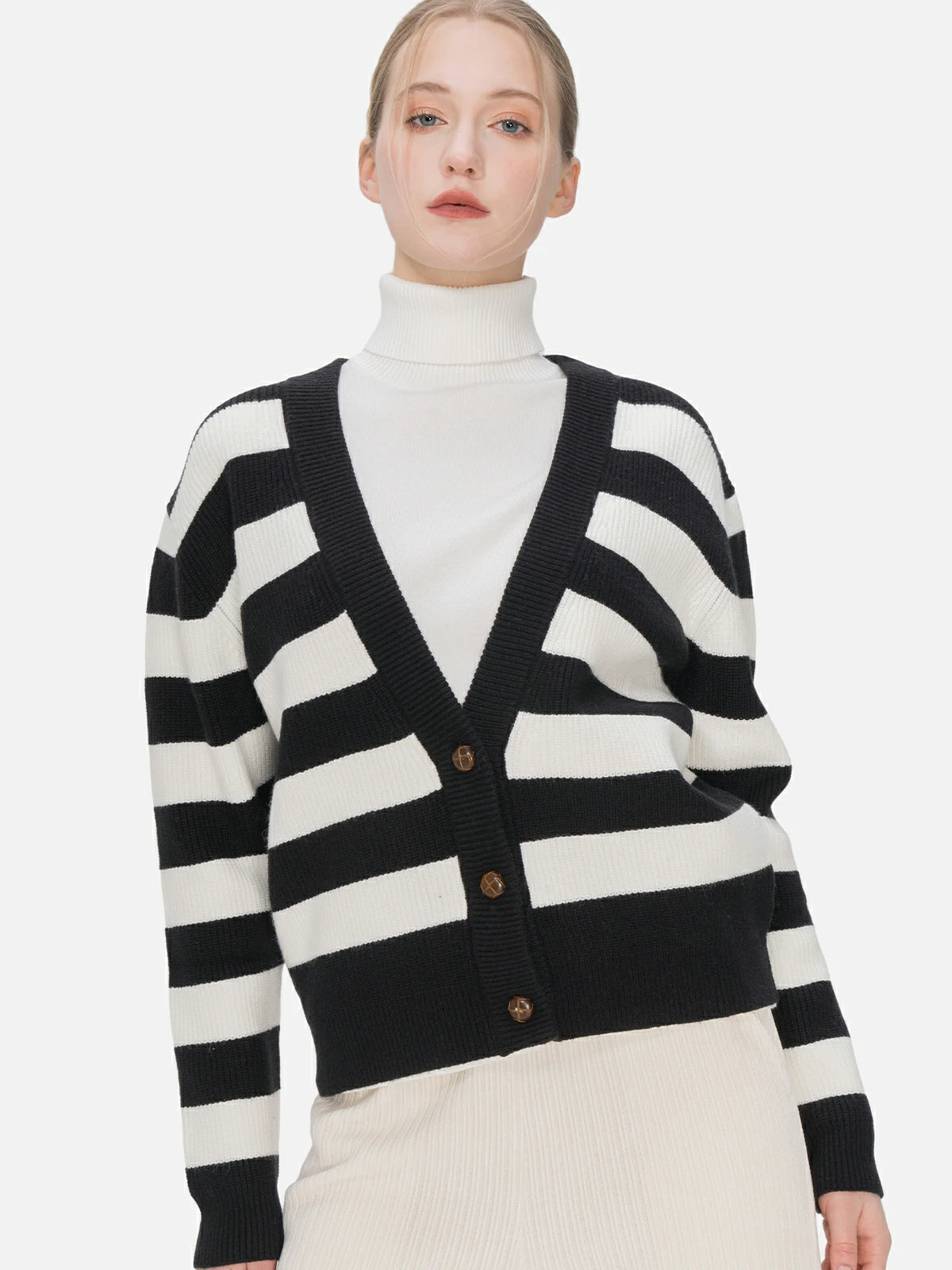 Elevate your style with this loose-fit V-neck cardigan featuring classic black and white stripes, stylish button details.