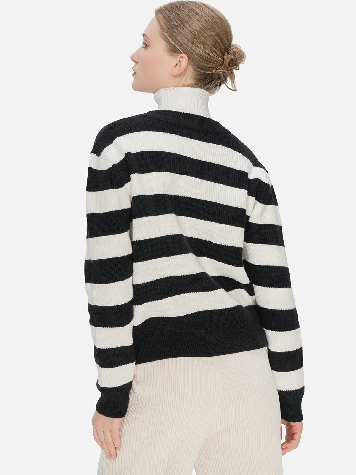 Stay on-trend with a loose-fit V-neck cardigan, showcasing a classic black and white striped pattern, stylish button embellishments, and a perfect balance of fashion and comfort.