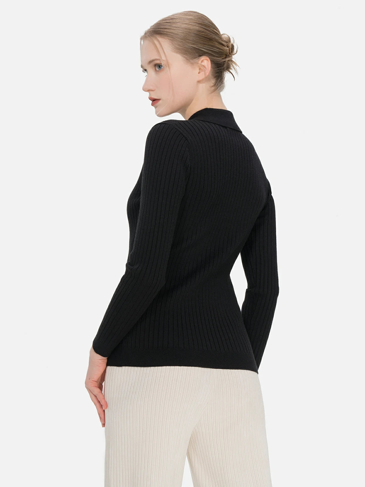 Experience the versatility of this black polo collar sweater, enhanced by a buttoned front and a slim fit.