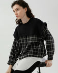 A chic and cozy shirt with knitted and checkered fabric features