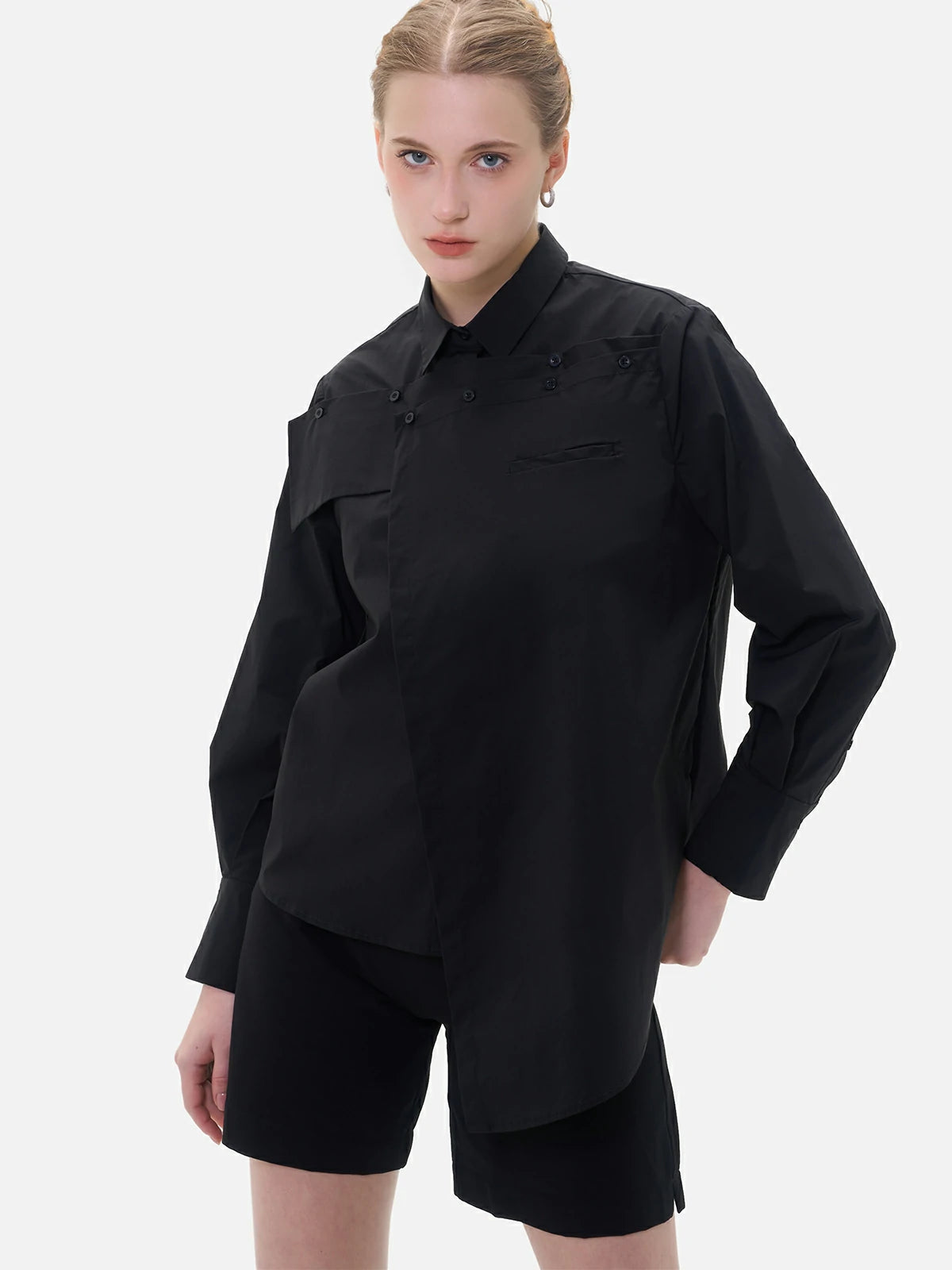 Stylish black shirt with a unique chest panel design, perfect for both professional and casual occasions.