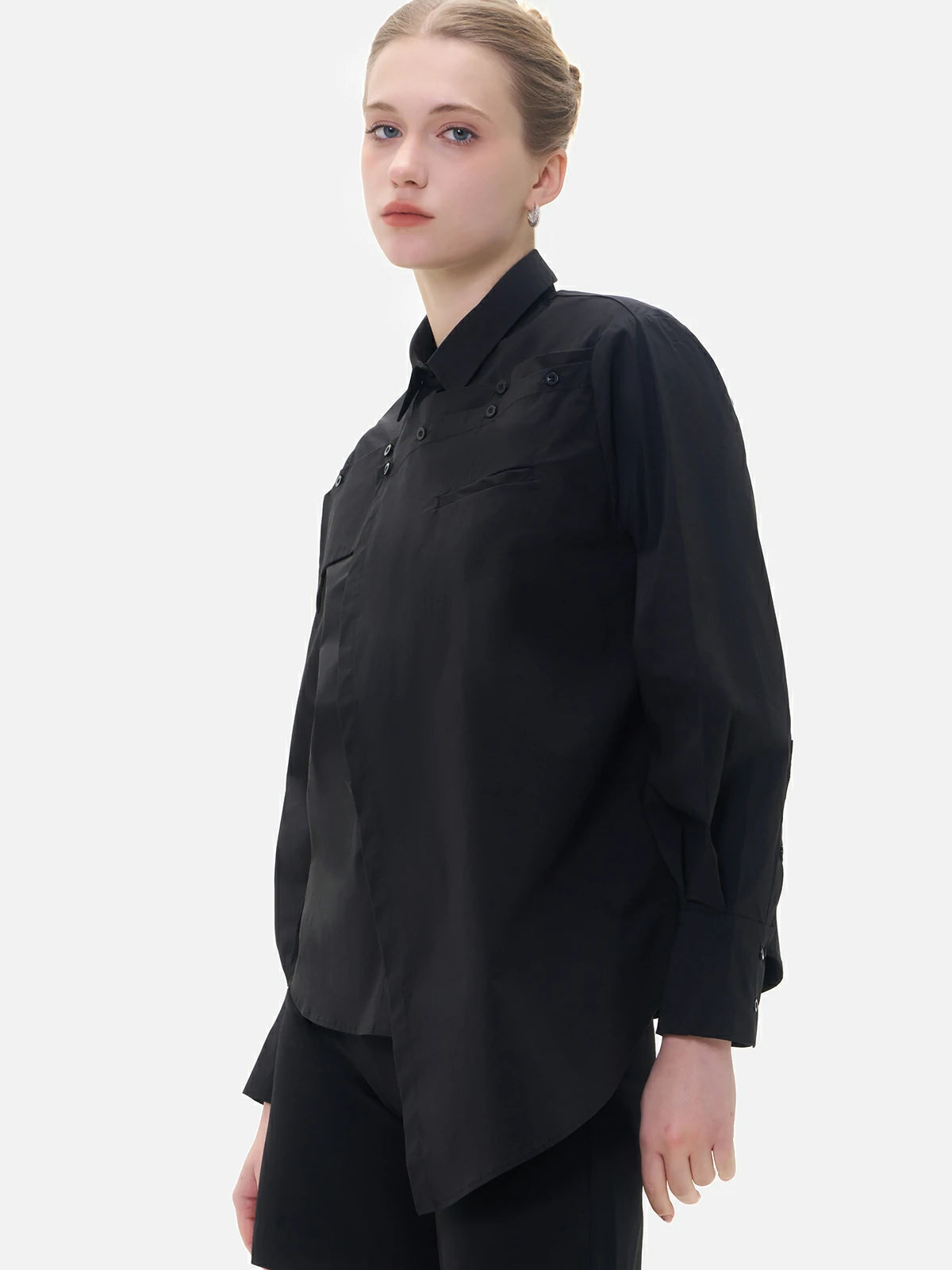 Versatile black shirt featuring a sophisticated chest panel, adding a touch of fashion-forward detailing for a polished look.