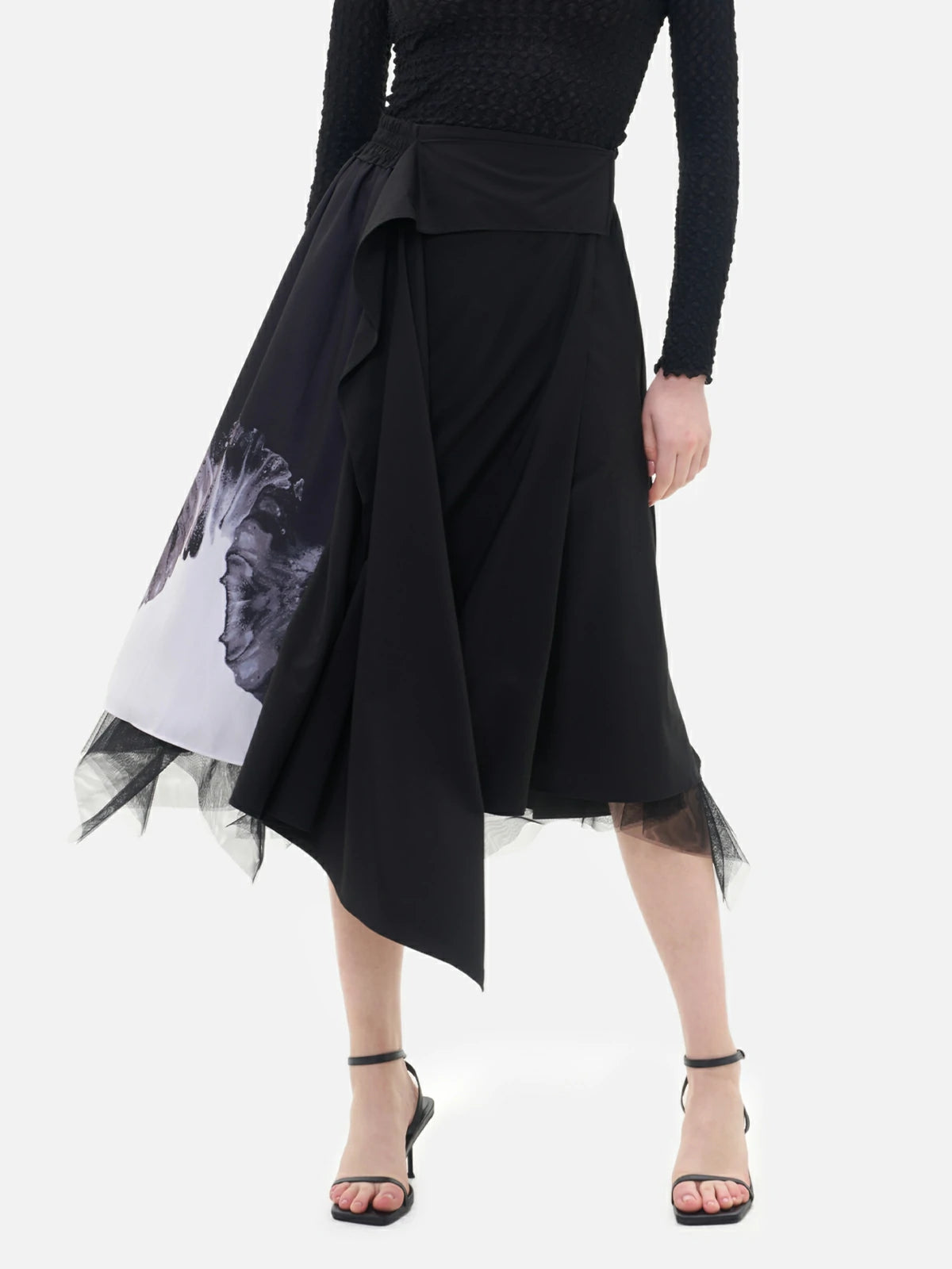 Elevate your style with this reversible panel skirt, featuring a abstract print design and delicate mesh detailing at the hem.