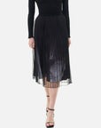 This double-layer skirt features a pleated inner lining, a black-and-white printed pattern, and a structured silhouette.