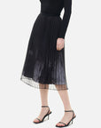 This versatile double-layered skirt, showcases pleats on the inner lining, a fashionable black-and-white printed patterns.