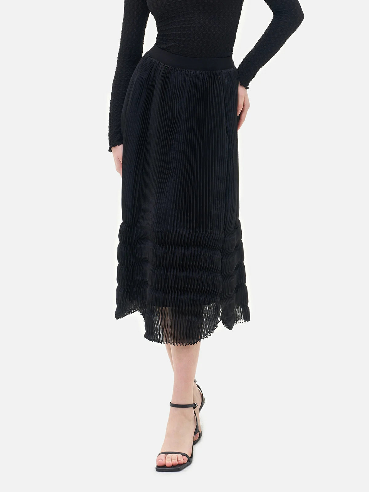 A stylish black semi-transparent midi skirt with V-shaped pleats, showcasing the unique and elegant charm of women.