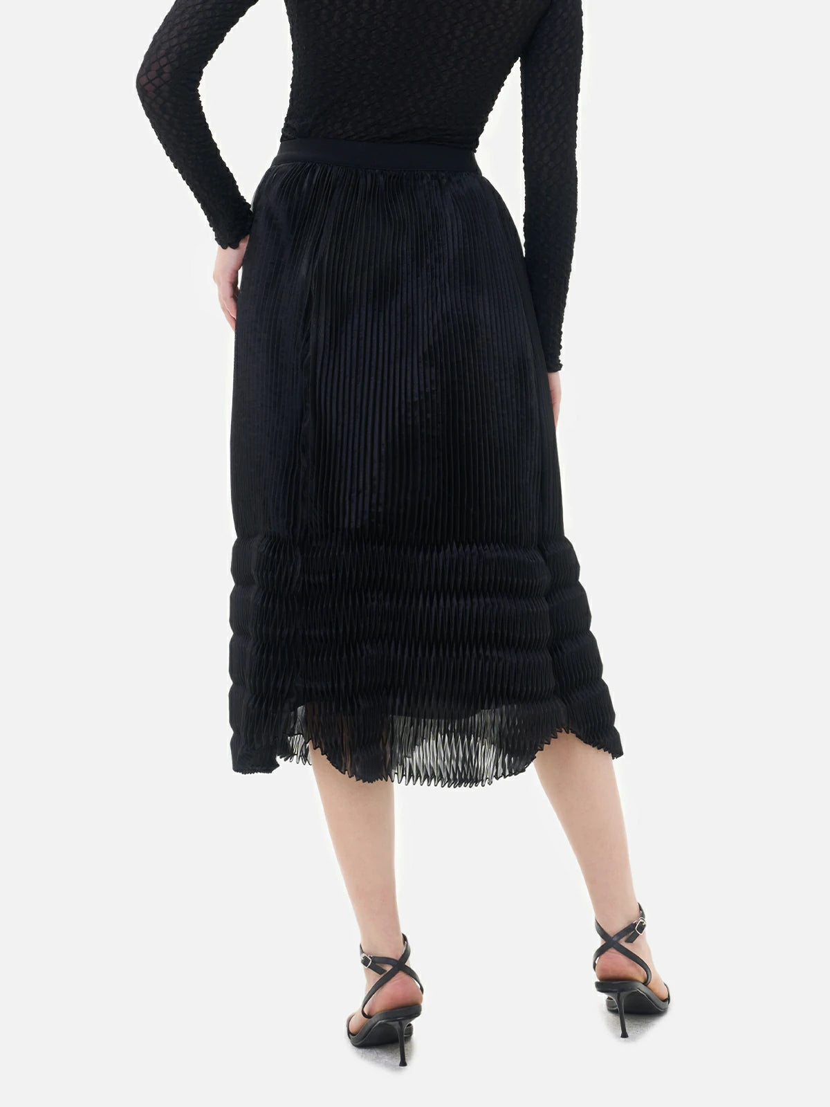 A both stylish and elegant black V-shaped pleated semi-transparent midi skirt, suitable for various occasions.