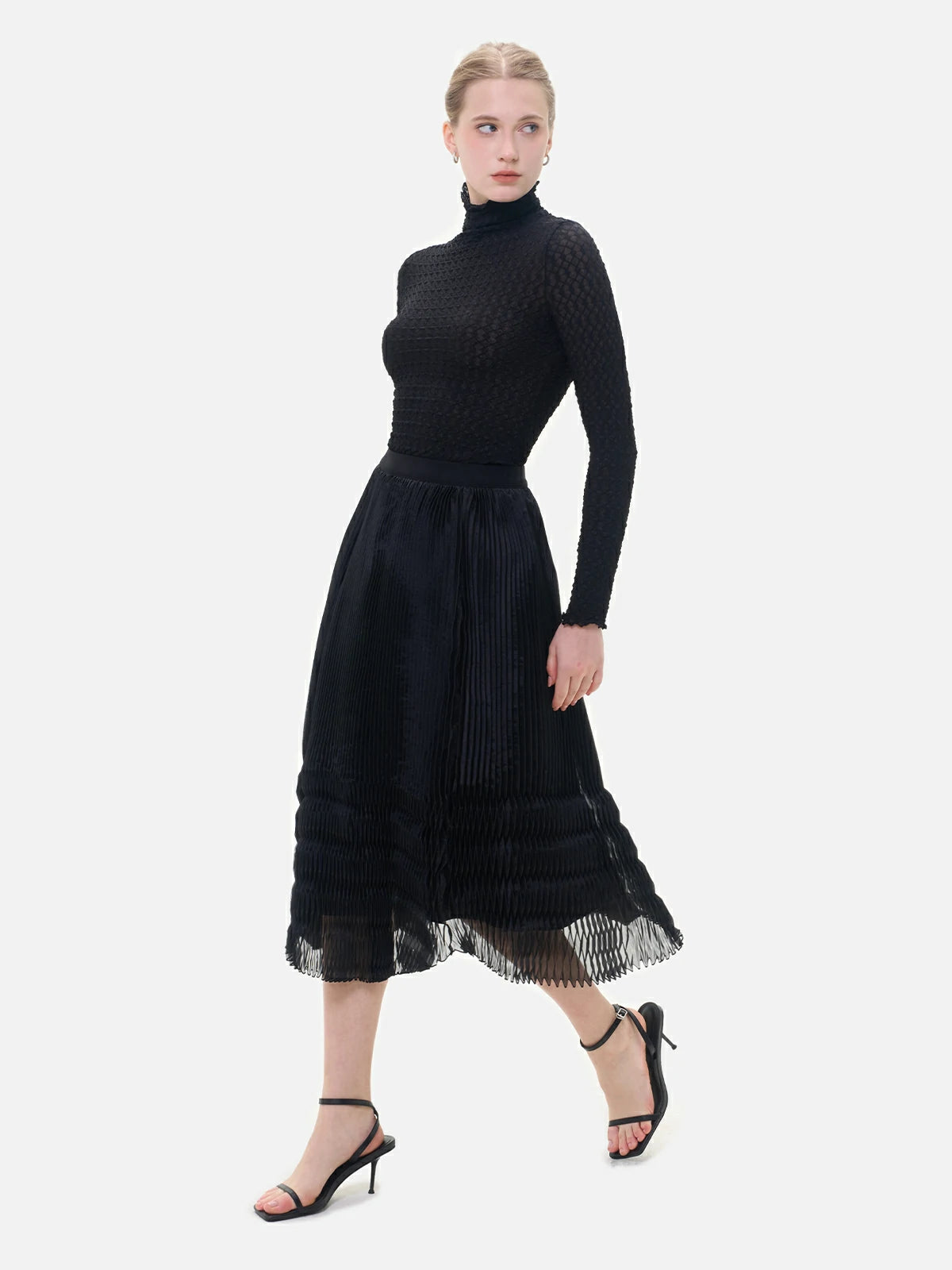 An elegant and stylish black semi-transparent skirt with V-shaped pleats, perfectly showcasing the charm of women.