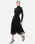 An elegant and stylish black semi-transparent skirt with V-shaped pleats, perfectly showcasing the charm of women.