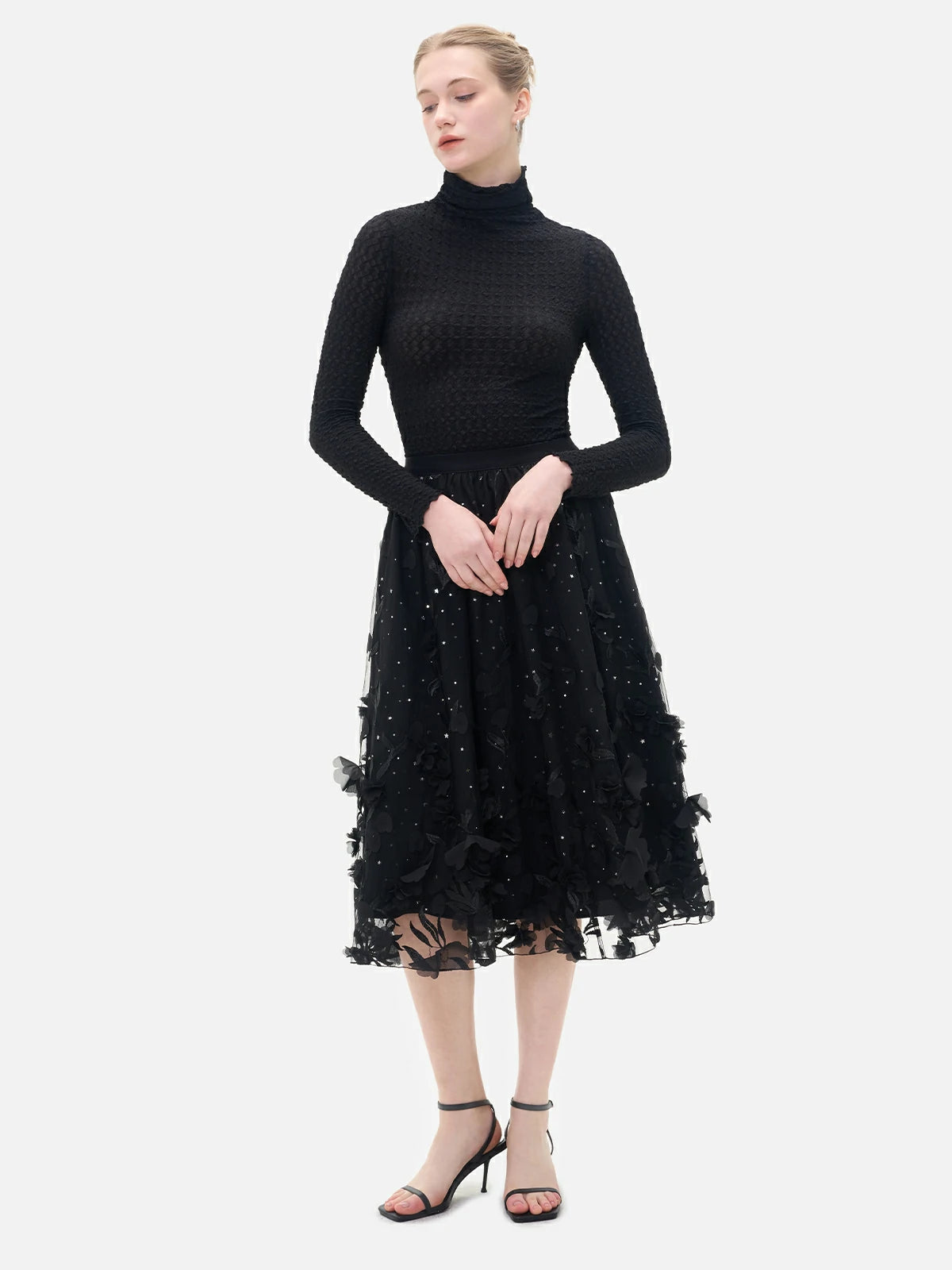 A classic yet stylish choice, this black double-layered skirt with intricate details is ideal for expressing individuality with sophistication.