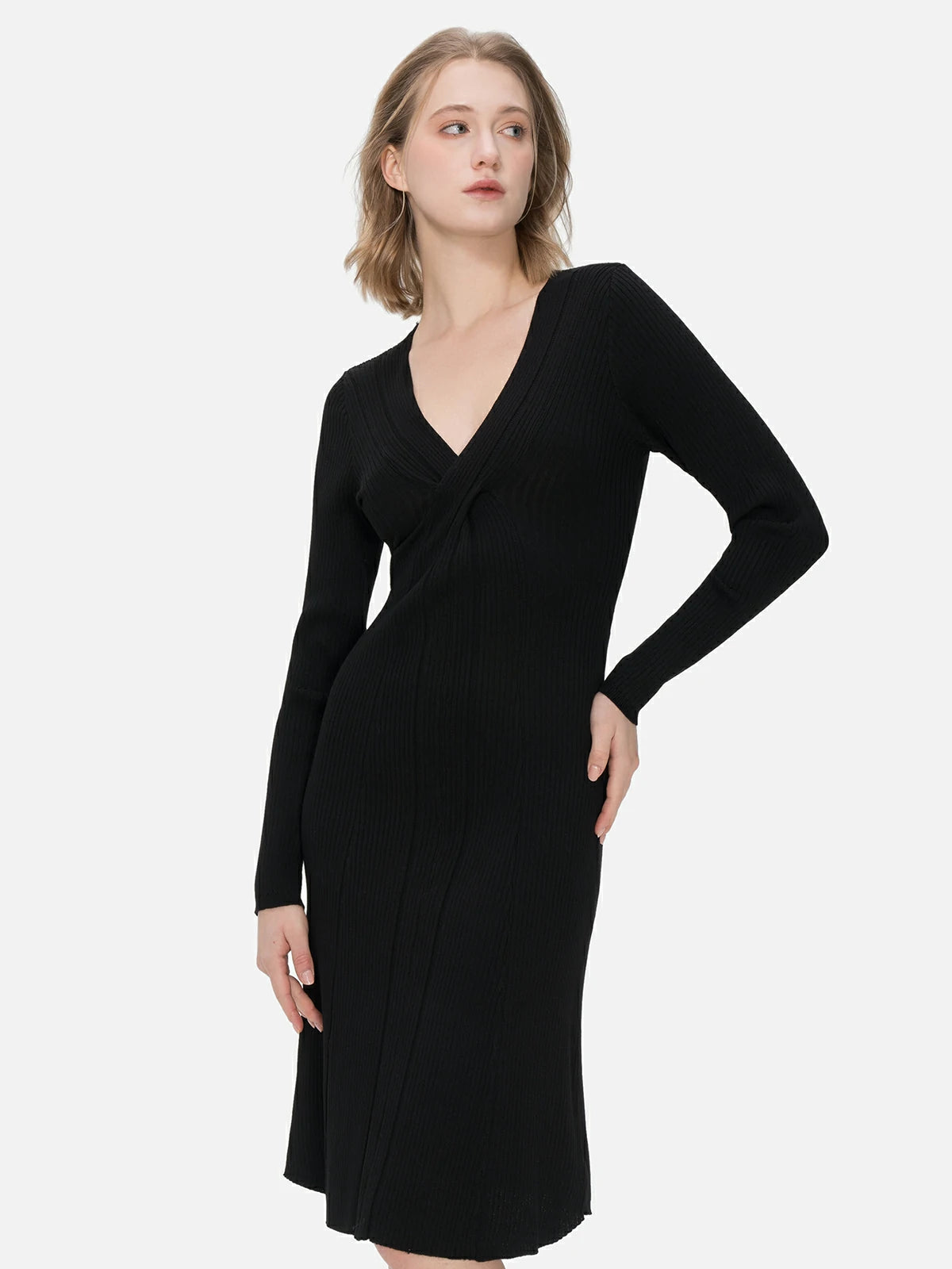 Redefine your wardrobe with this body-hugging black knit midi dress, adorned with a cross V-neck design and intricate knit details.