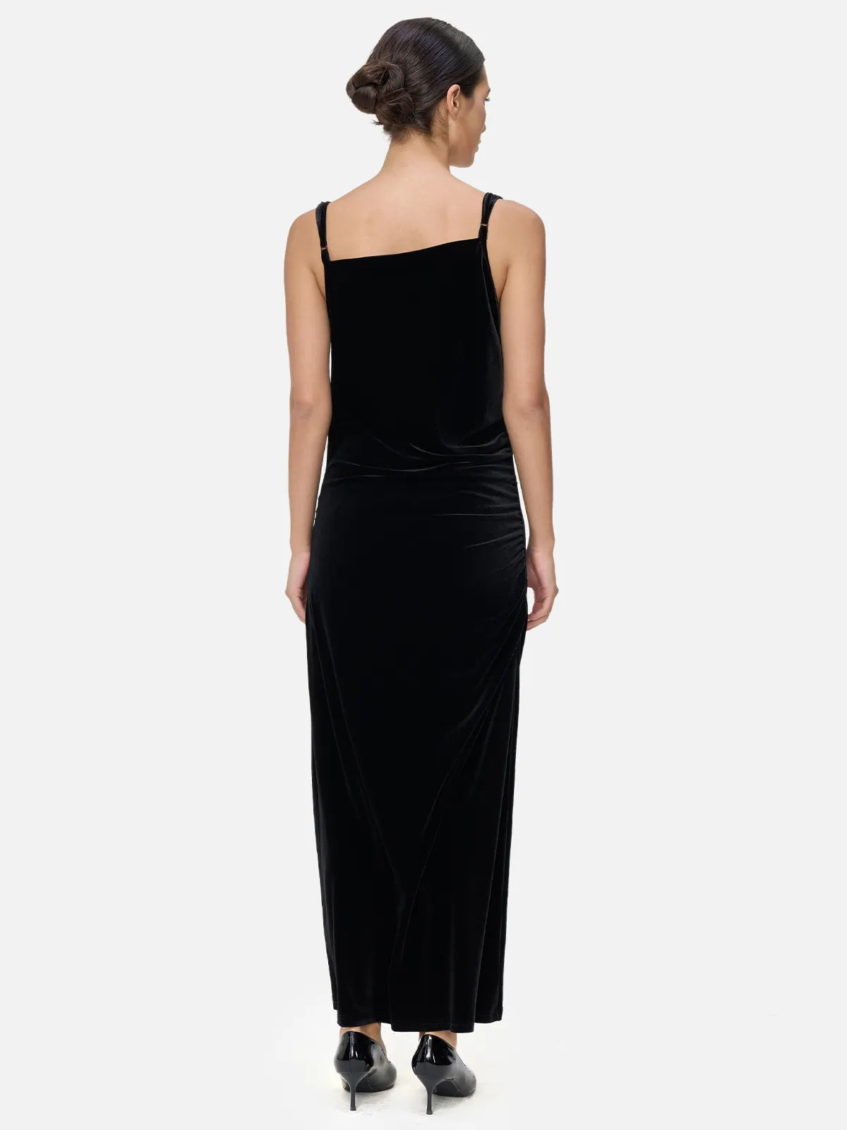 Luxurious and sophisticated ambiance in a velvet spaghetti strap maxi dress with irregular V-neck design